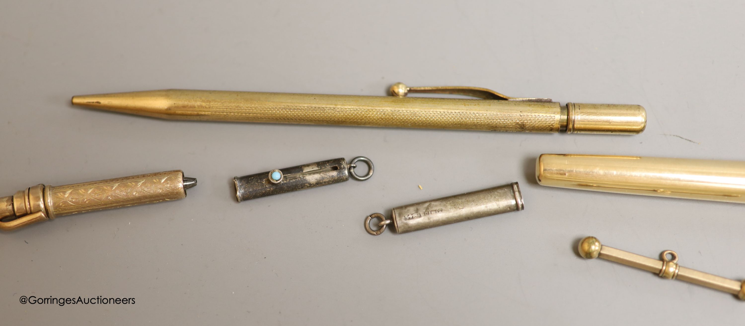 Rolled gold pens and pencils including a T-bar and two silver cased pencils.